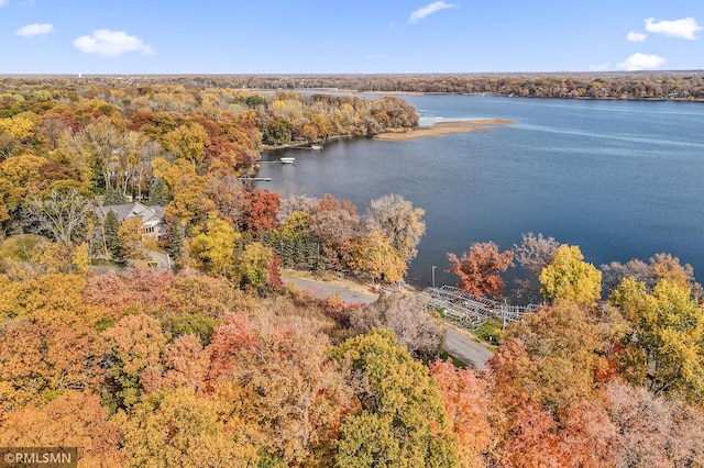 aerial view with a forest view and a water view
