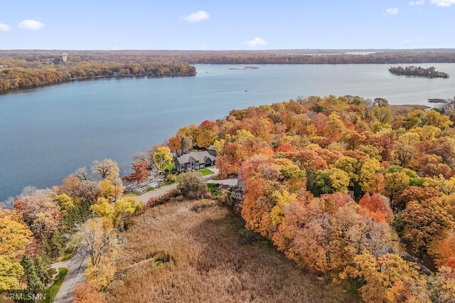 aerial view featuring a water view and a wooded view