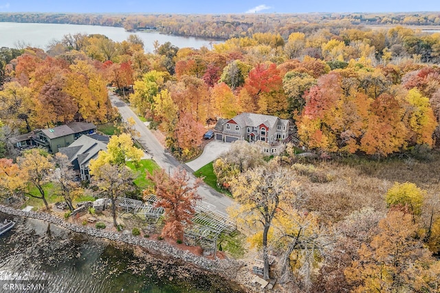 bird's eye view with a water view and a forest view
