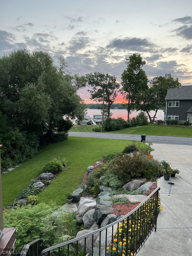 exterior space with a lawn and a water view