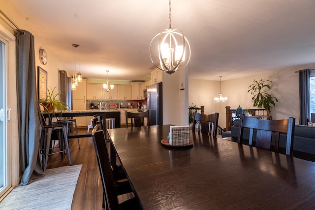 dining room with a notable chandelier and dark wood-type flooring