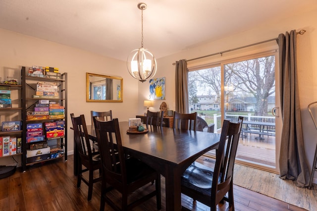 dining room featuring dark wood-style floors and a chandelier