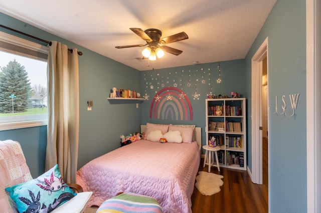 bedroom with a ceiling fan and wood finished floors