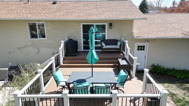 308 16th Ave SW, Austin, MN 55912 - rear view of property featuring outdoor dining space, a wooden deck, and a shingled roof