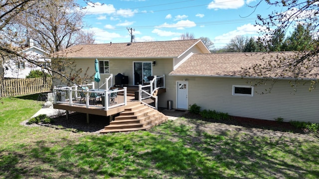 308 16th Ave SW, Austin, MN 55912 - rear view of property with a yard, a deck, a shingled roof, and fence