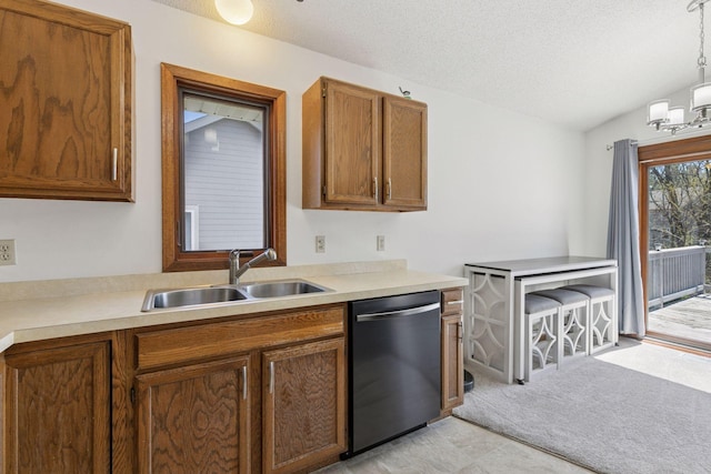 kitchen featuring a sink, light countertops, brown cabinets, and dishwasher
