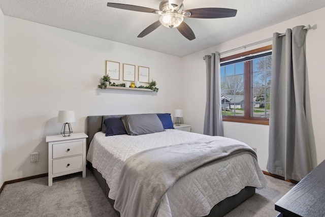 carpeted bedroom featuring baseboards, a textured ceiling, and ceiling fan