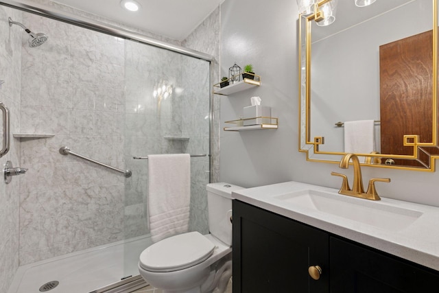 bathroom with vanity, a stall shower, and toilet
