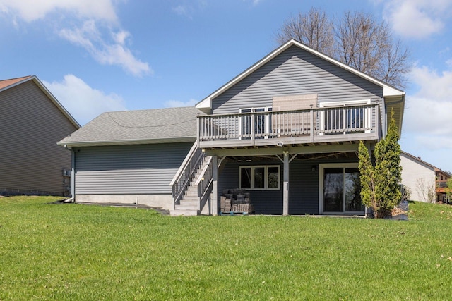 back of property featuring a lawn, a shingled roof, a wooden deck, and stairs
