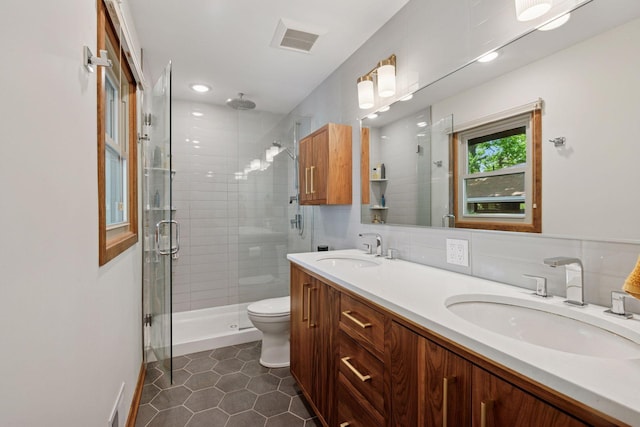 full bathroom featuring a shower stall, tile patterned flooring, double vanity, toilet, and recessed lighting