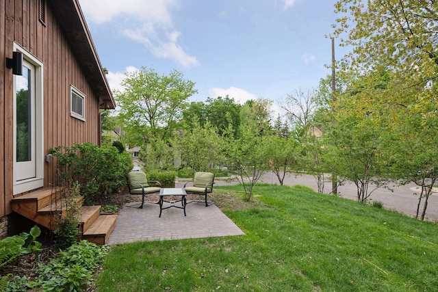 view of green lawn with a patio area