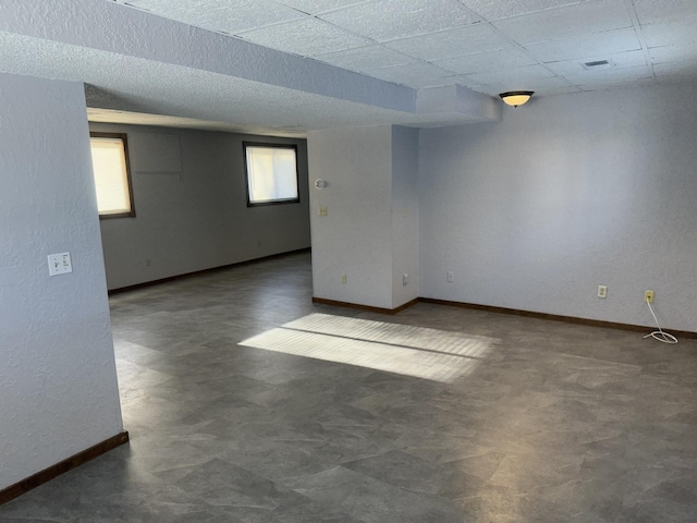 153 10th Ave N, Waite Park, MN 56387 - unfurnished room featuring visible vents, a textured wall, baseboards, a paneled ceiling, and tile patterned floors