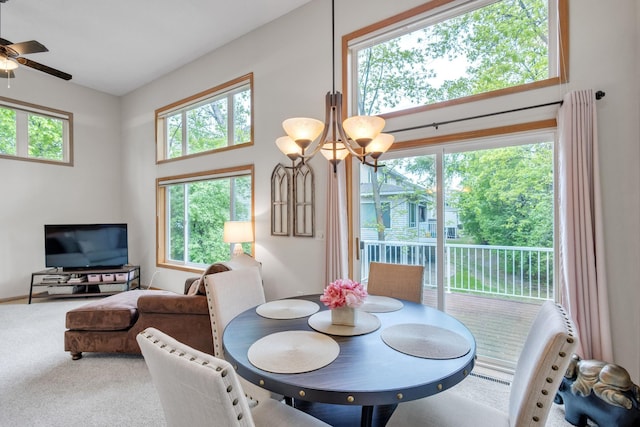 carpeted dining space with ceiling fan