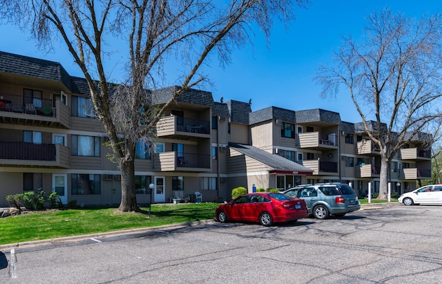 view of building exterior with uncovered parking