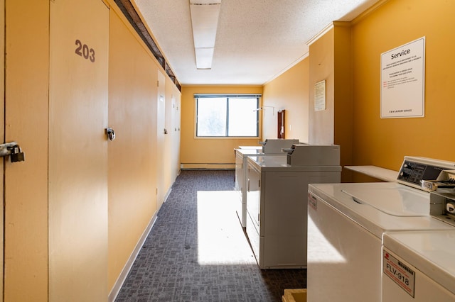 common laundry area with washing machine and dryer, dark colored carpet, baseboards, and a baseboard heating unit