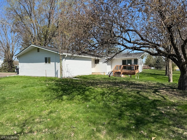 exterior space featuring a deck and a lawn