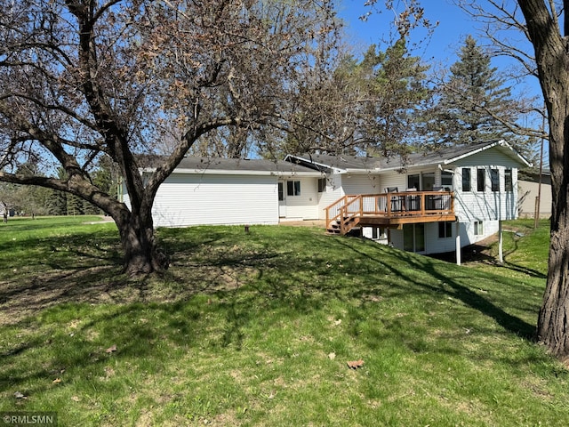 back of house with a yard and a deck