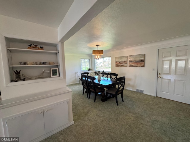 dining area with a textured ceiling, carpet, baseboards, visible vents, and a chandelier