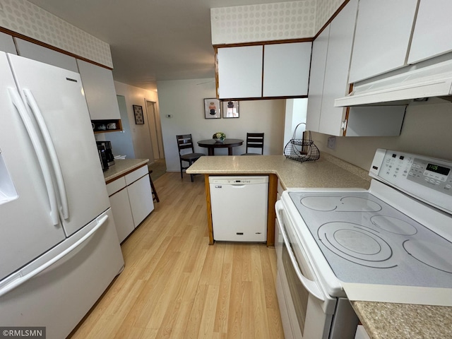 kitchen with light wood-style flooring, white cabinets, white appliances, under cabinet range hood, and light countertops