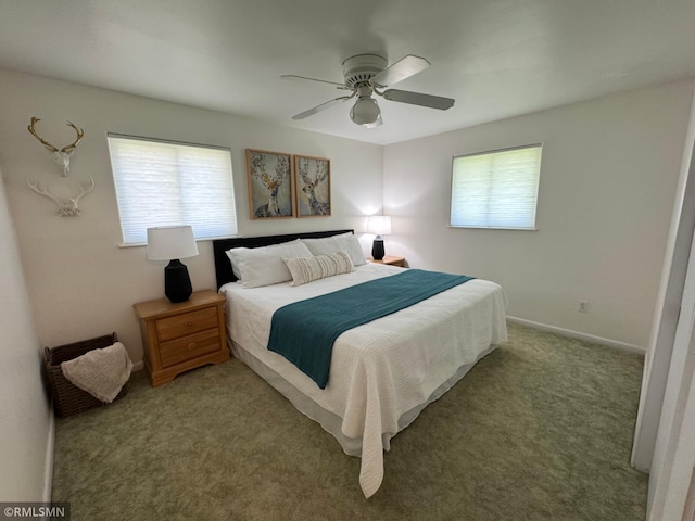 bedroom with ceiling fan, light carpet, and baseboards