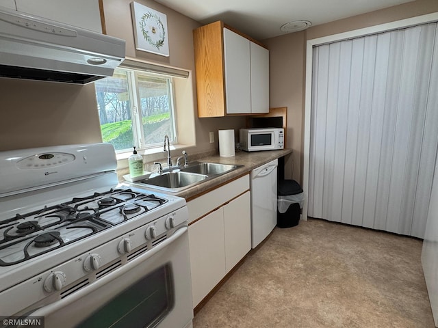 kitchen with a sink, ventilation hood, white cabinets, white appliances, and light colored carpet