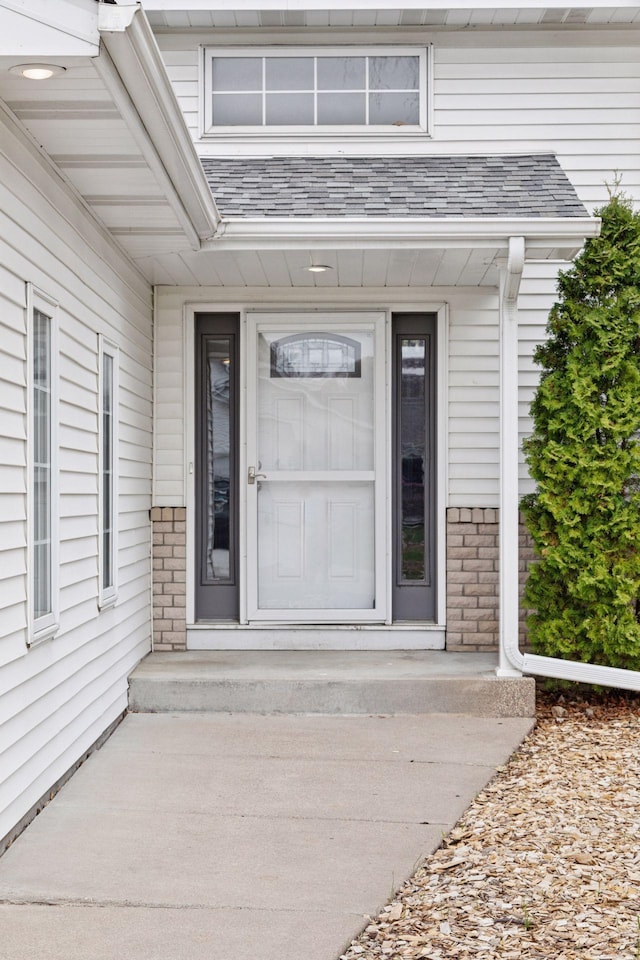 doorway to property with brick siding