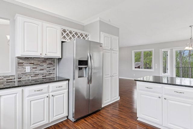 kitchen featuring white cabinets, stainless steel fridge with ice dispenser, dark stone countertops, dark wood-type flooring, and backsplash