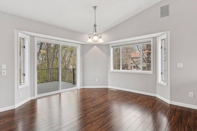 unfurnished dining area with baseboards, a notable chandelier, wood finished floors, and visible vents