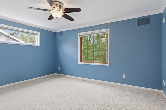 unfurnished room with ornamental molding, carpet, and visible vents