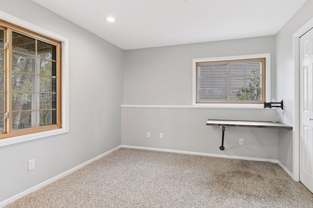carpeted empty room featuring baseboards and recessed lighting