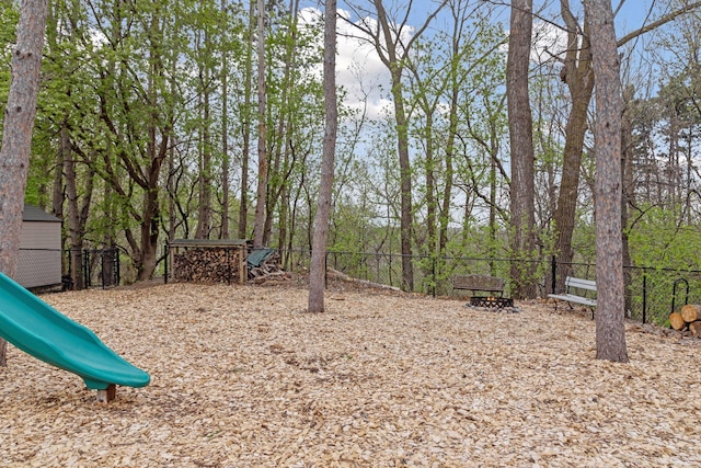 view of yard with a playground and fence