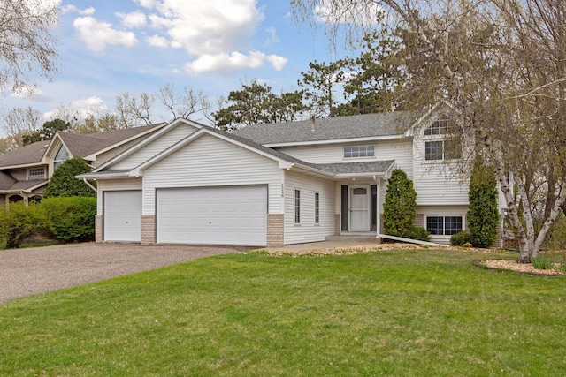 view of front of property featuring roof with shingles, an attached garage, aphalt driveway, brick siding, and a front yard