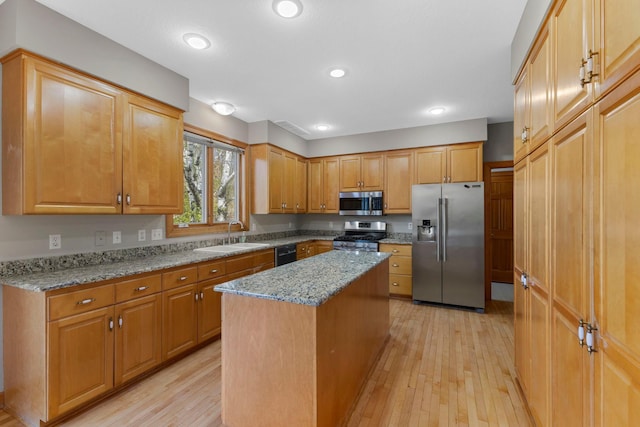 3088 Canyon Rd, Chaska, MN 55318 - kitchen with a sink, appliances with stainless steel finishes, light stone countertops, and light wood finished floors