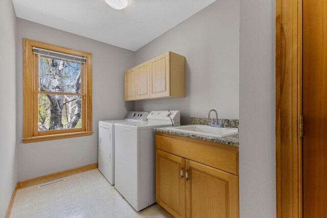3088 Canyon Rd, Chaska, MN 55318 - clothes washing area featuring cabinet space, a sink, separate washer and dryer, baseboards, and visible vents