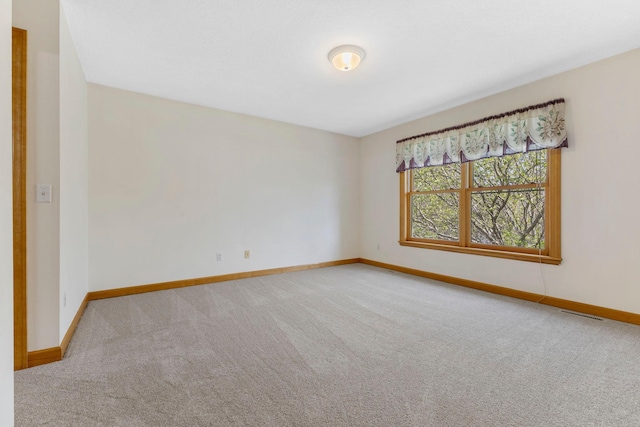 3088 Canyon Rd, Chaska, MN 55318 - spare room featuring baseboards, visible vents, and carpet