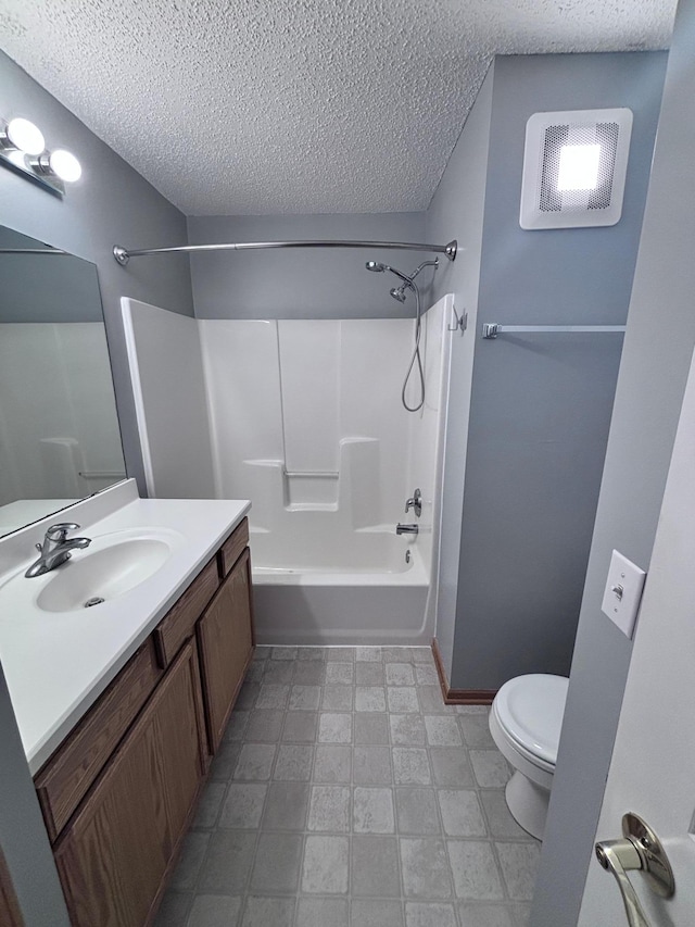 bathroom featuring vanity, toilet, baseboards, shower / tub combination, and a textured ceiling