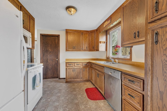224 Spring St, Holdingford, MN 56340 - kitchen featuring a sink, white appliances, light countertops, and brown cabinets