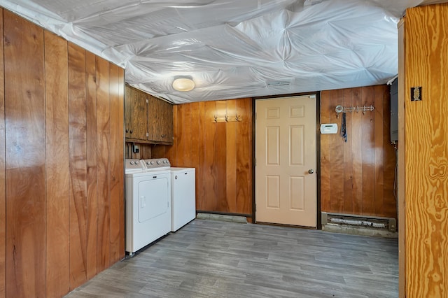 224 Spring St, Holdingford, MN 56340 - clothes washing area with wood walls, cabinet space, independent washer and dryer, and wood finished floors