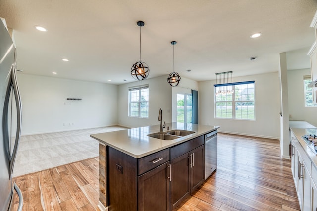 15637 Eddy Creek Way, Apple Valley, MN 55124 - kitchen with a sink, stainless steel appliances, open floor plan, light wood finished floors, and recessed lighting