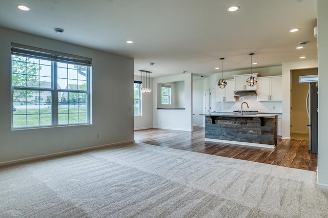 15637 Eddy Creek Way, Apple Valley, MN 55124 - unfurnished living room featuring recessed lighting, dark wood-type flooring, baseboards, and a sink