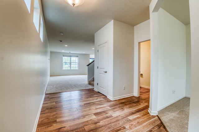 15637 Eddy Creek Way, Apple Valley, MN 55124 - hallway featuring wood finished floors, baseboards, stairway, and recessed lighting