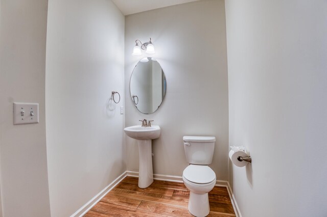 15637 Eddy Creek Way, Apple Valley, MN 55124 - half bathroom featuring wood finished floors, toilet, baseboards, and a sink