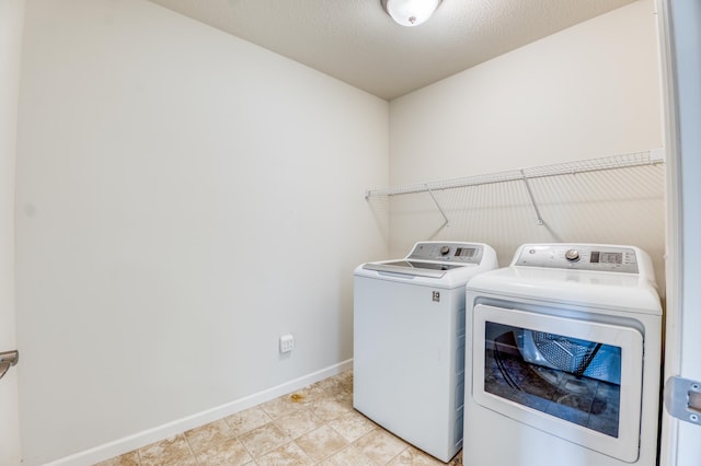 15637 Eddy Creek Way, Apple Valley, MN 55124 - laundry area with washing machine and clothes dryer, baseboards, and light tile patterned flooring