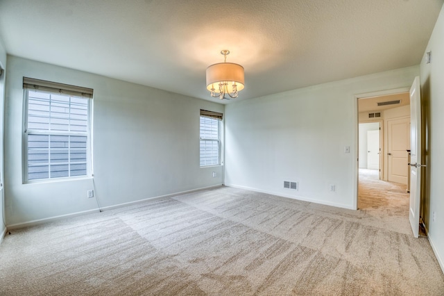 15637 Eddy Creek Way, Apple Valley, MN 55124 - spare room with carpet, a chandelier, baseboards, and a textured ceiling