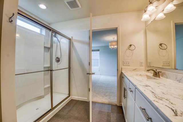 15637 Eddy Creek Way, Apple Valley, MN 55124 - bathroom featuring vanity, a shower with shower door, plenty of natural light, and baseboards