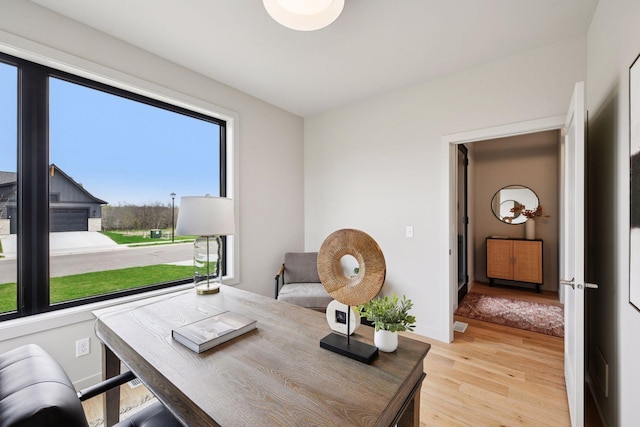 office area featuring light wood-style floors and baseboards