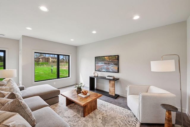 living area featuring baseboards, recessed lighting, and wood finished floors