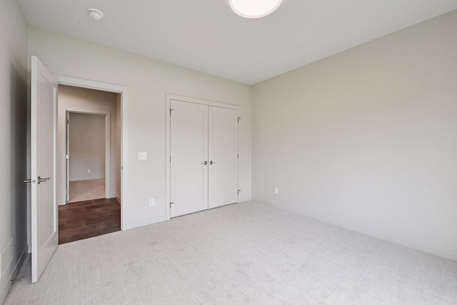 unfurnished bedroom with carpet and a closet