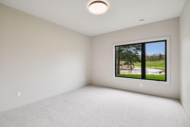 empty room with carpet floors and baseboards
