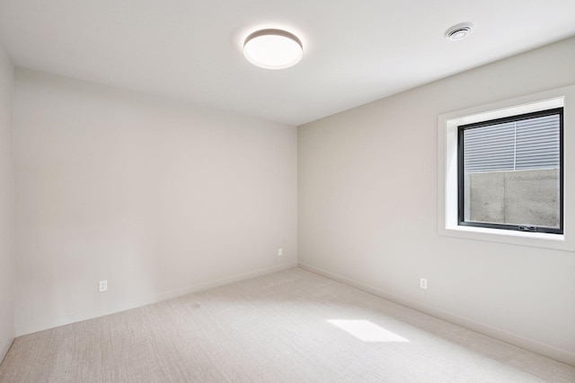 empty room featuring baseboards, carpet flooring, and visible vents